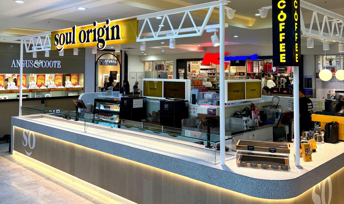 Modern retail store interior with 'Soul Origin' and 'Gourmet' signs.